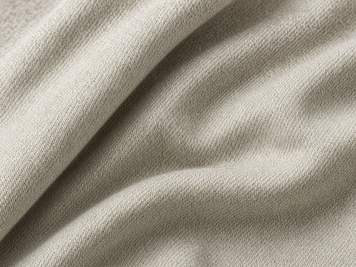 Fine knit apparel fabric with visible stitch structure.
